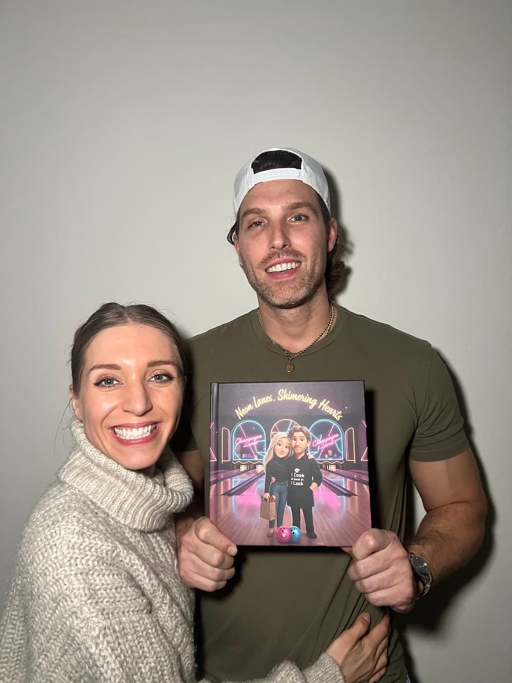 A customer couple holding their printed Love Tales book