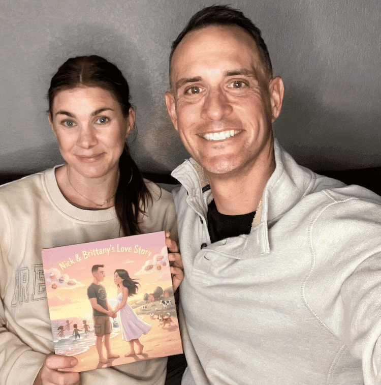 A couple taking a selfie with their personalized Love Tales book