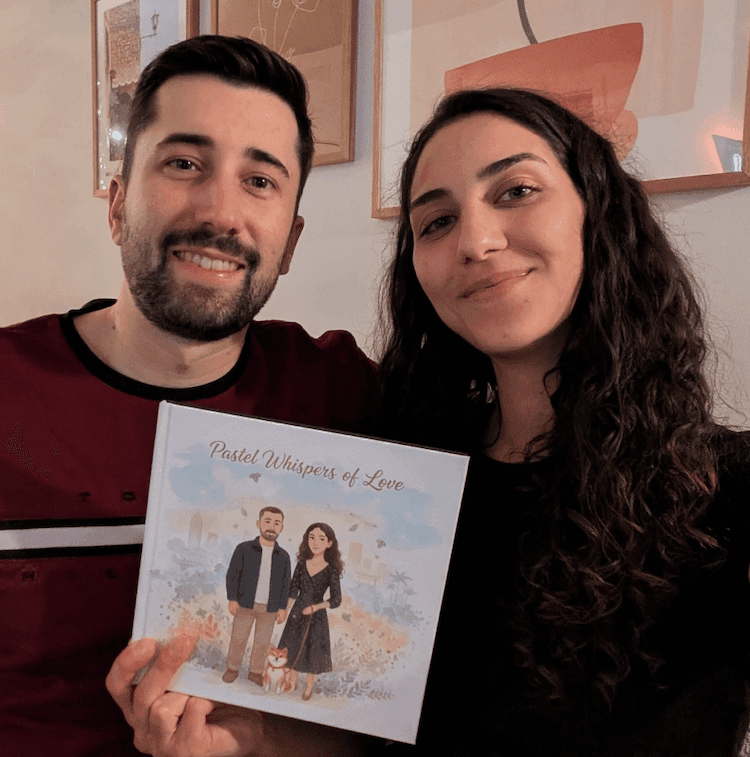 A smiling couple holding their personalized Love Tales book
