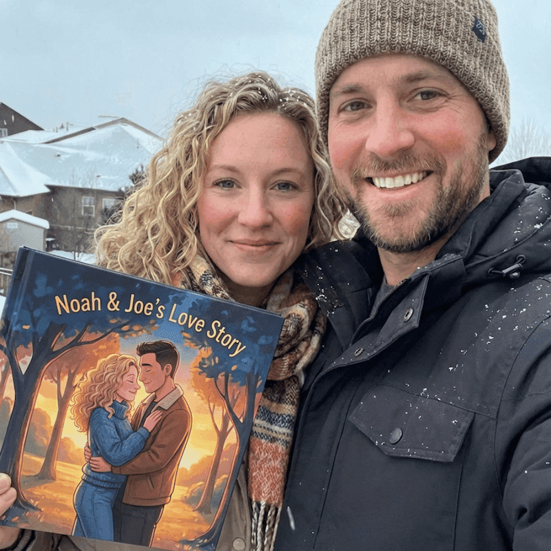 A couple holding their personalized anniversary book